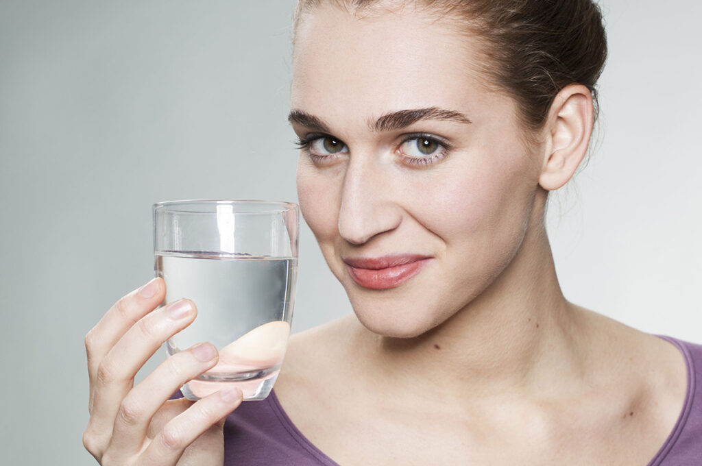 donna con bicchiere d'acqua